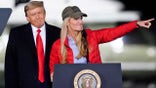 Sen. Kelly Loeffler, R-Ga., speaks as President Donald Trump listens during a campaign rally in support of Senate candidates Sen. Kelly Loeffler, R-Ga., and David Perdue in Dalton, Ga., Monday, Jan. 4, 2021. (AP Photo/Brynn Anderson)