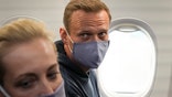 Alexei Navalny and his wife, Yulia sit in the plane prior to their flight to Moscow in the Airport Berlin Brandenburg (BER) in Schoenefeld, near Berlin, Germany, Sunday, Jan. 17, 2021.