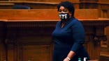 Democrat Stacey Abrams, walks on Senate floor before of members of Georgia's Electoral College cast their votes at the state Capitol, Monday, Dec. 14, 2020, in Atlanta. (AP Photo/John Bazemore, Pool)
