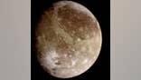 Natural color view of Ganymede from the Galileo spacecraft during its first encounter with the satellite. North is to the top of the picture and the sun illuminates the surface from the right. The dark areas are the older, more heavily cratered regions and the light areas are younger, tectonically deformed regions. Image Credit: NASA/JPL