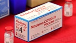 A box of vials of the Moderna vaccine for the COVID-19 coronavirus on display during a press conference with Florida governor Ron DeSantis touting the expanded rollout of the state vaccination program, at Orlando Health South Seminole Hospital in Longwood, Fla., Monday, Jan. 4, 2021. (Joe Burbank/Orlando Sentinel via AP)