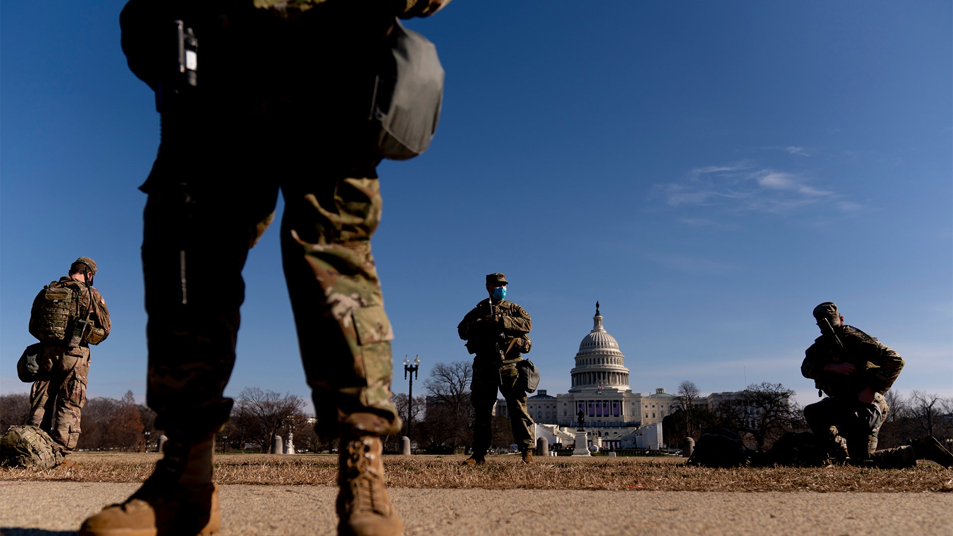 Armed members of the National Guard stand guard outside the Capitol Building on Capitol Hill in Washington, Thursday, Jan. 14, 2021. (AP Photo/Andrew Harnik)