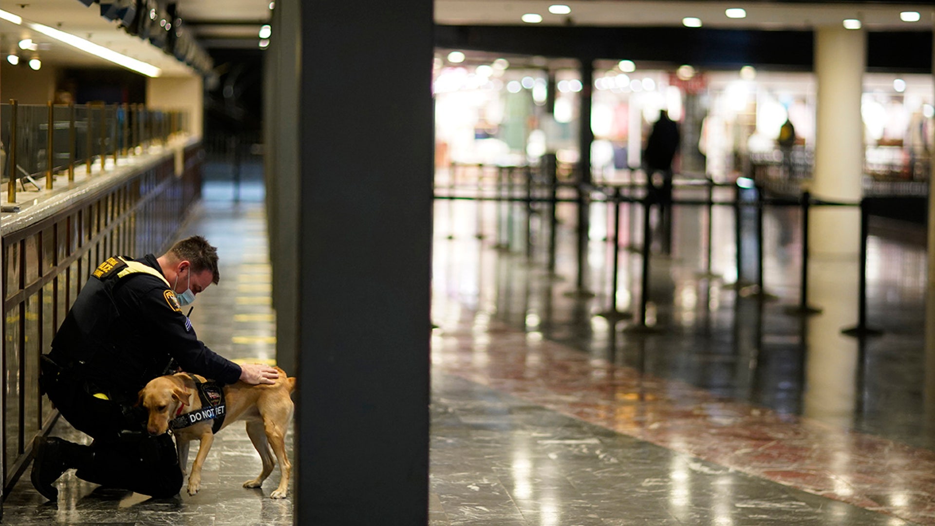 An Amtrak K9 officer pets his dog after checking passengers from Union Station as security is heightened ahead of President-elect Joe Biden's inauguration ceremony, Tuesday, Jan. 19, 2021, in Washington.
