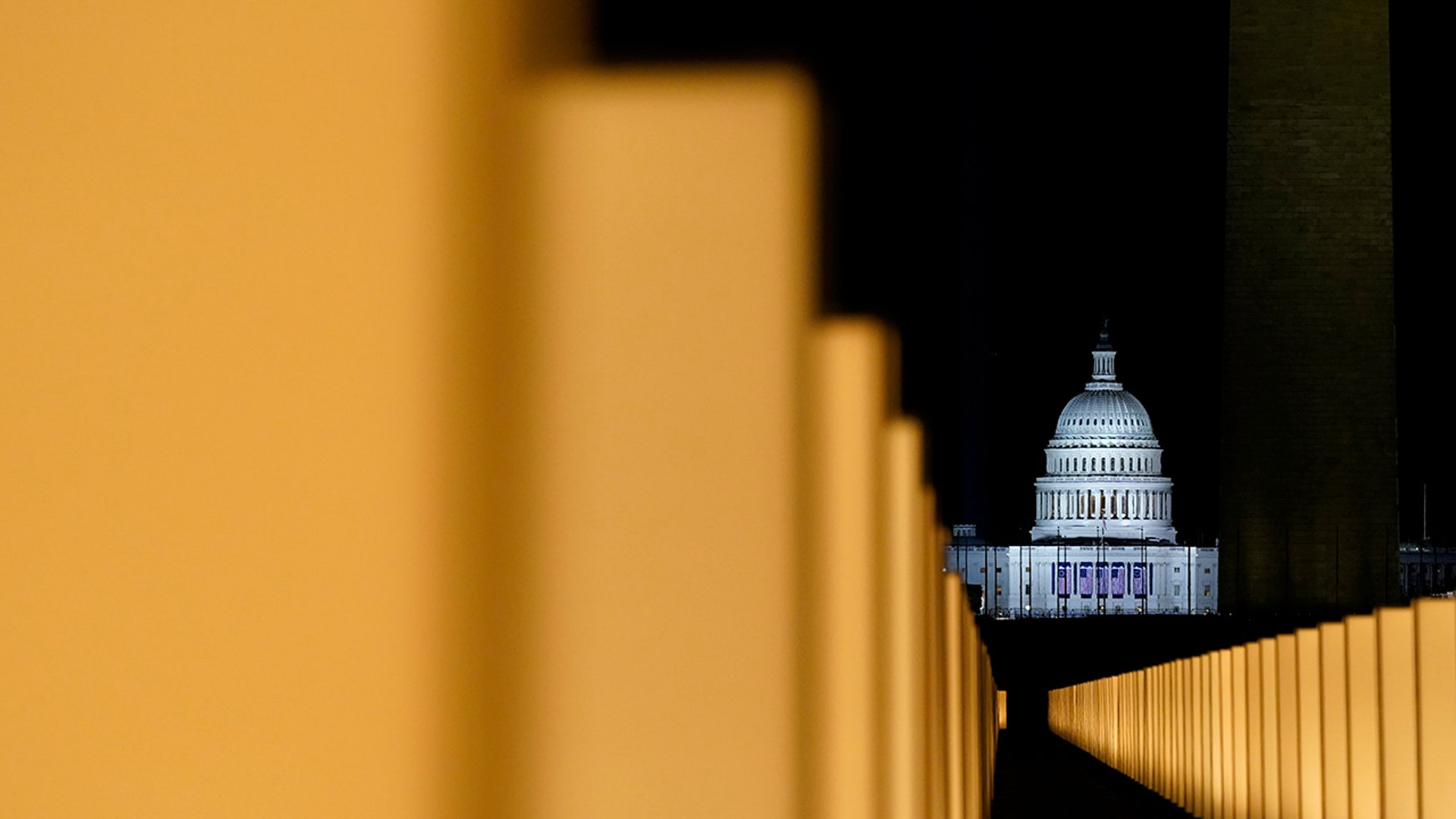 Lights surround the Lincoln Memorial Reflecting Pool, placed as a memorial to COVID-19 victims Tuesday, Jan. 19, 2021, in Washington, after President-elect Joe Biden spoke, with the U.S. Capitol in the background.