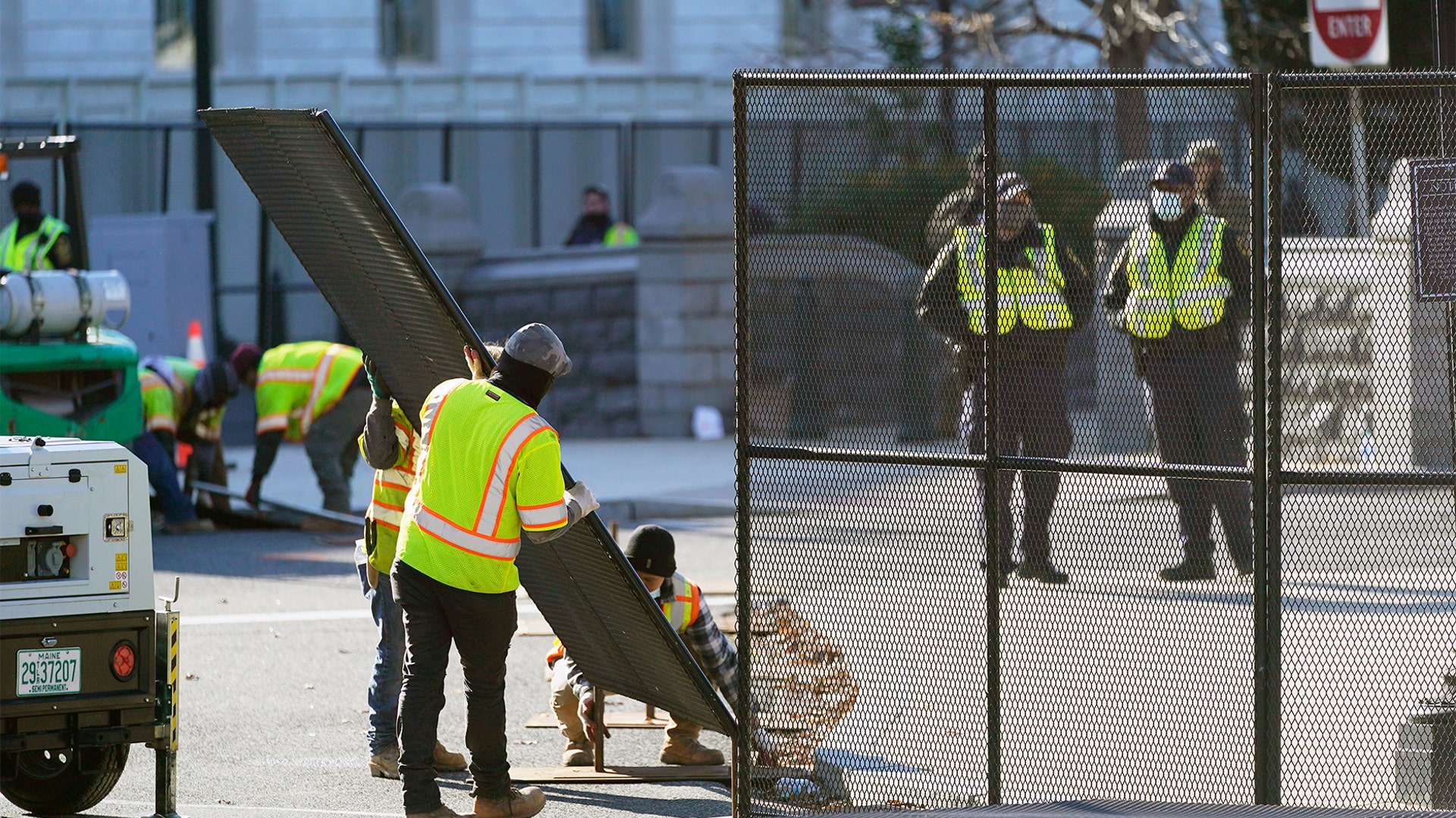 Fencing is placed around the exterior of the Capitol grounds, Thursday morning, Jan. 7, 2021 in Washington. The House and Senate certified the Democrat's electoral college win early Thursday after a violent throng of pro-Trump rioters spent hours Wednesday running rampant through the Capitol. A woman was fatally shot, windows were bashed and the mob forced shaken lawmakers and aides to flee the building, shielded by Capitol Police. (AP Photo/Julio Cortez)