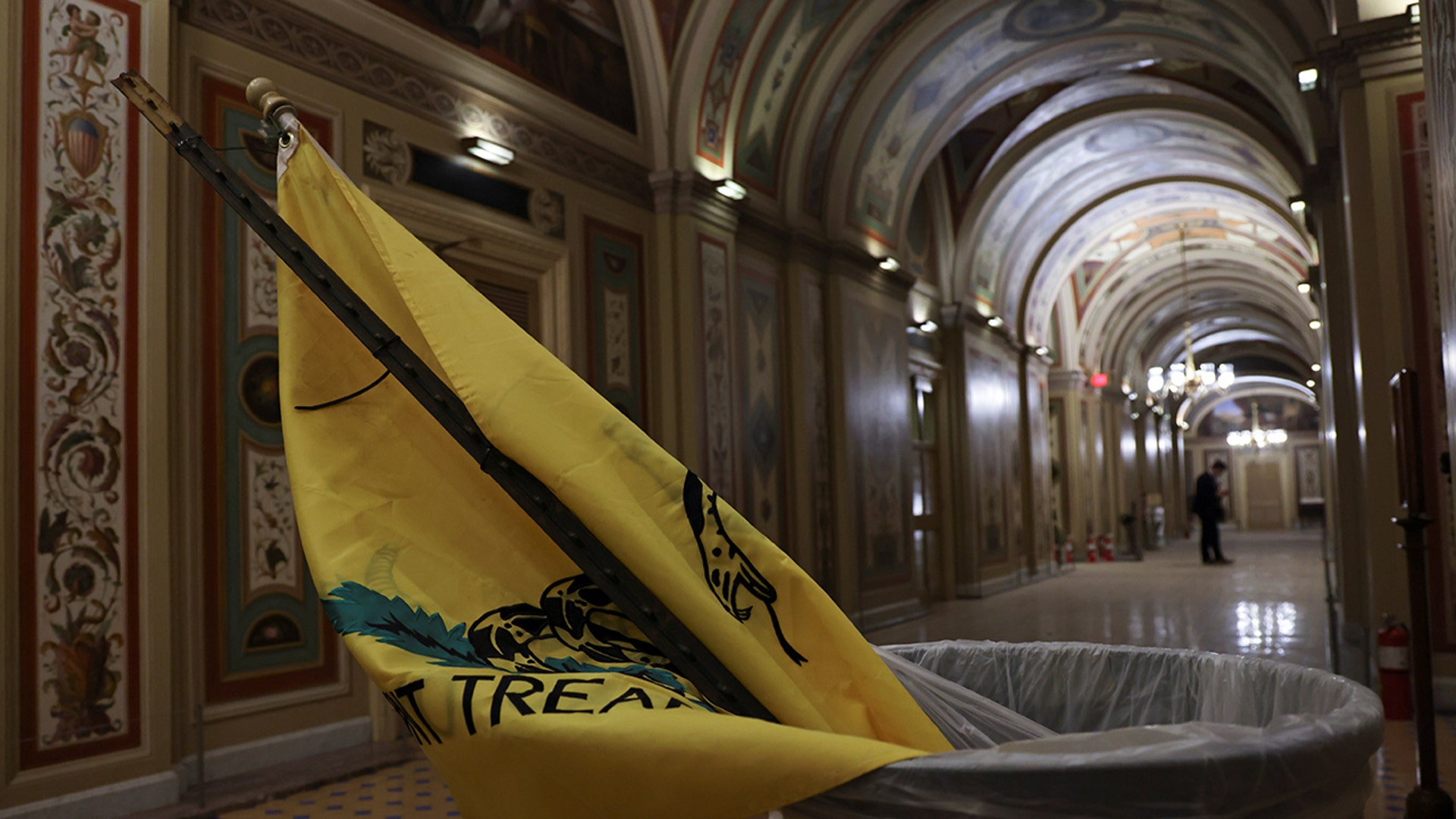 A flag is pictured in a trash can after supporters of President Donald Trump occupied the U.S. Capitol Building, in Washington, Jan. 7, 2021.