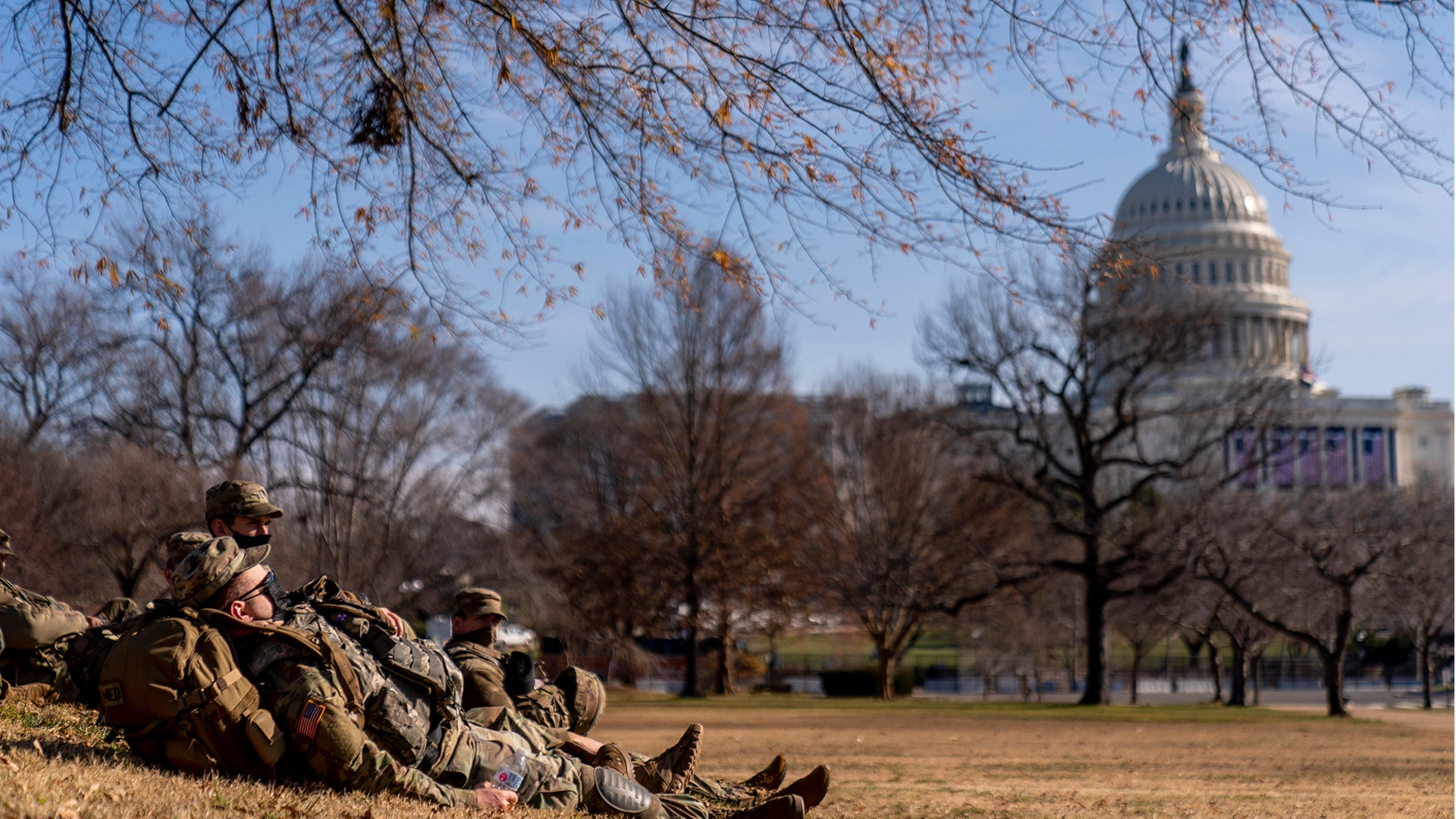 Members of the National Guard take a break while guarding the U.S. Capitol on Capitol Hill in Washington, Thursday, Jan. 14, 2021. (AP Photo/Andrew Harnik)