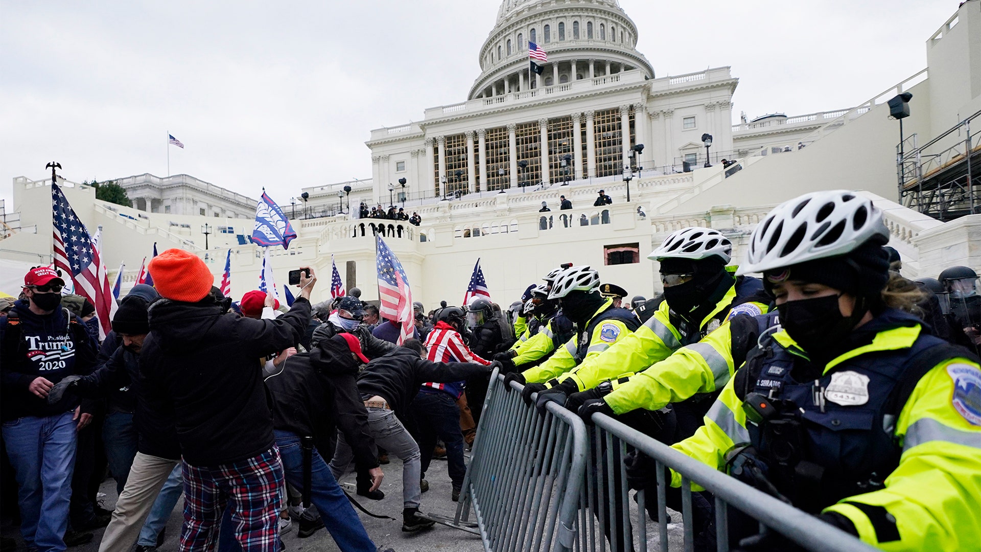 Trump supporters try to break through a police barrier, Wednesday, Jan. 6, 2021, at the Capitol in Washington. As Congress prepares to affirm President-elect Joe Biden's victory, thousands of people have gathered to show their support for President Trump and his claims of election fraud.