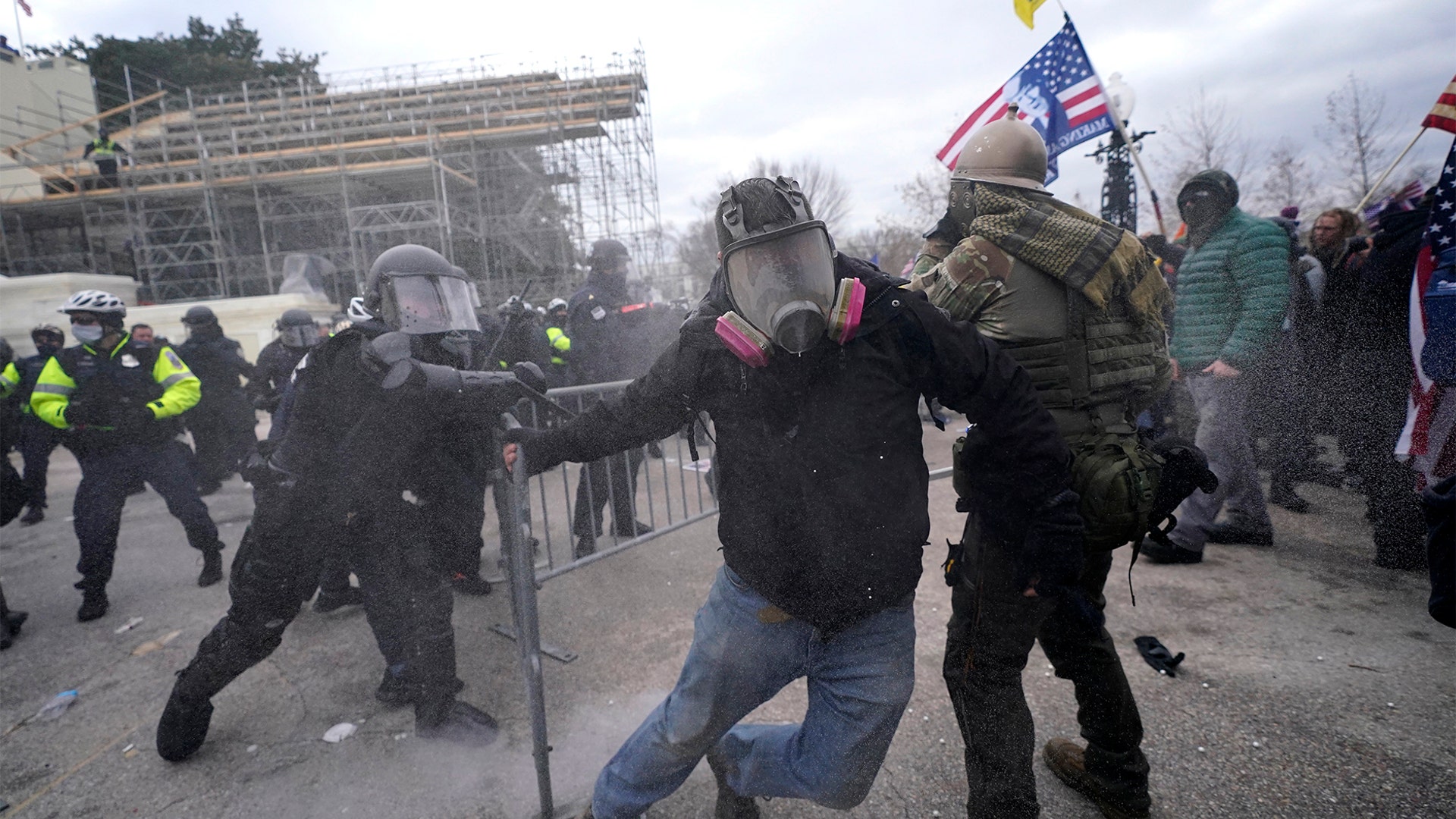 Trump supporters try to break through a police barrier, Wednesday, Jan. 6, 2021, at the Capitol in Washington. As Congress prepares to affirm President-elect Joe Biden's victory, thousands of people have gathered to show their support for President Trump and his claims of election fraud.