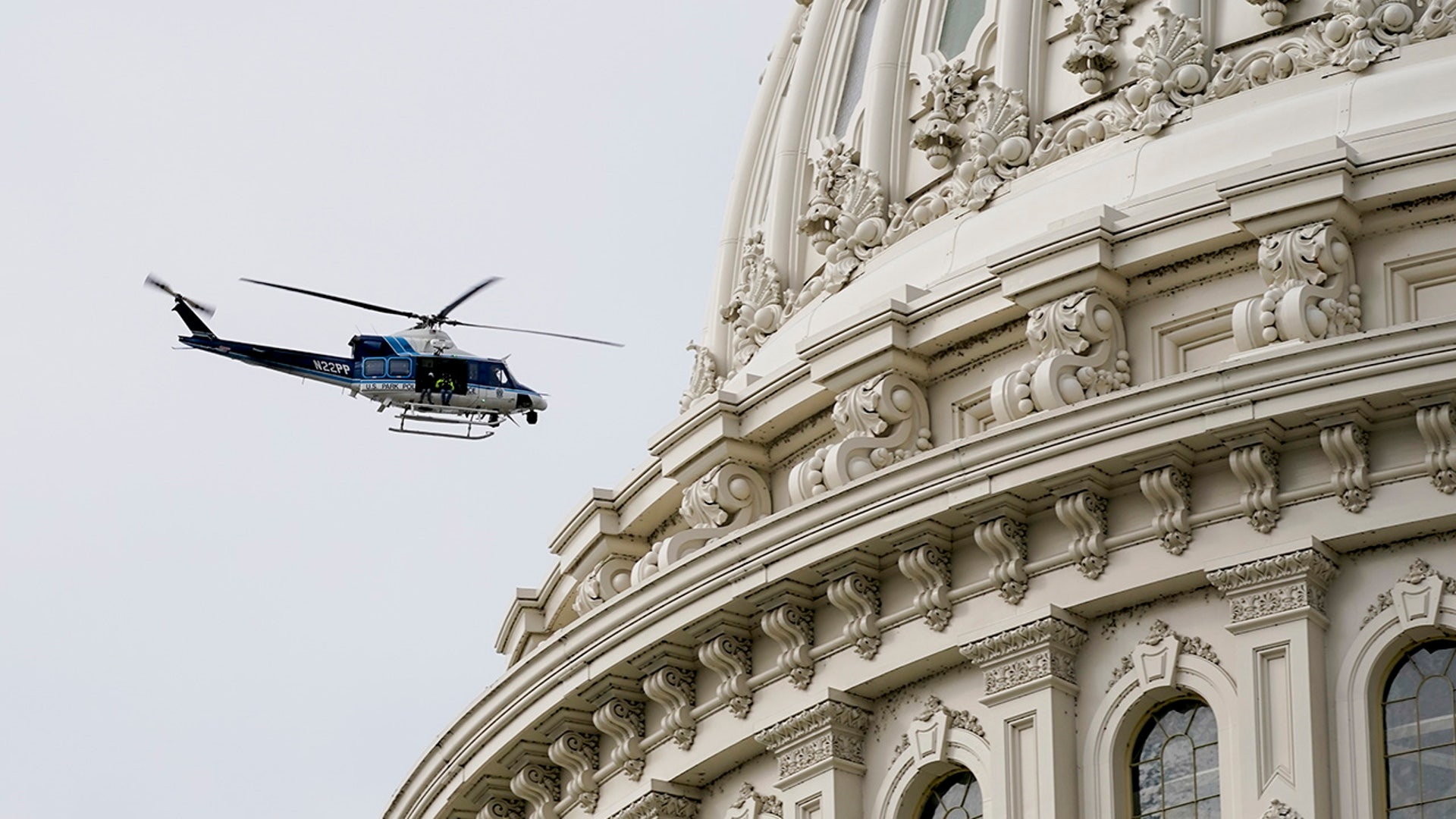 A U.S. Park Police helicopter circles the Capitol as a nearby fire prompted a temporary lockdown during a during a rehearsal for President-elect Joe Biden's inauguration ceremony, at the Capitol in Washington, Monday, Jan. 18, 2021.