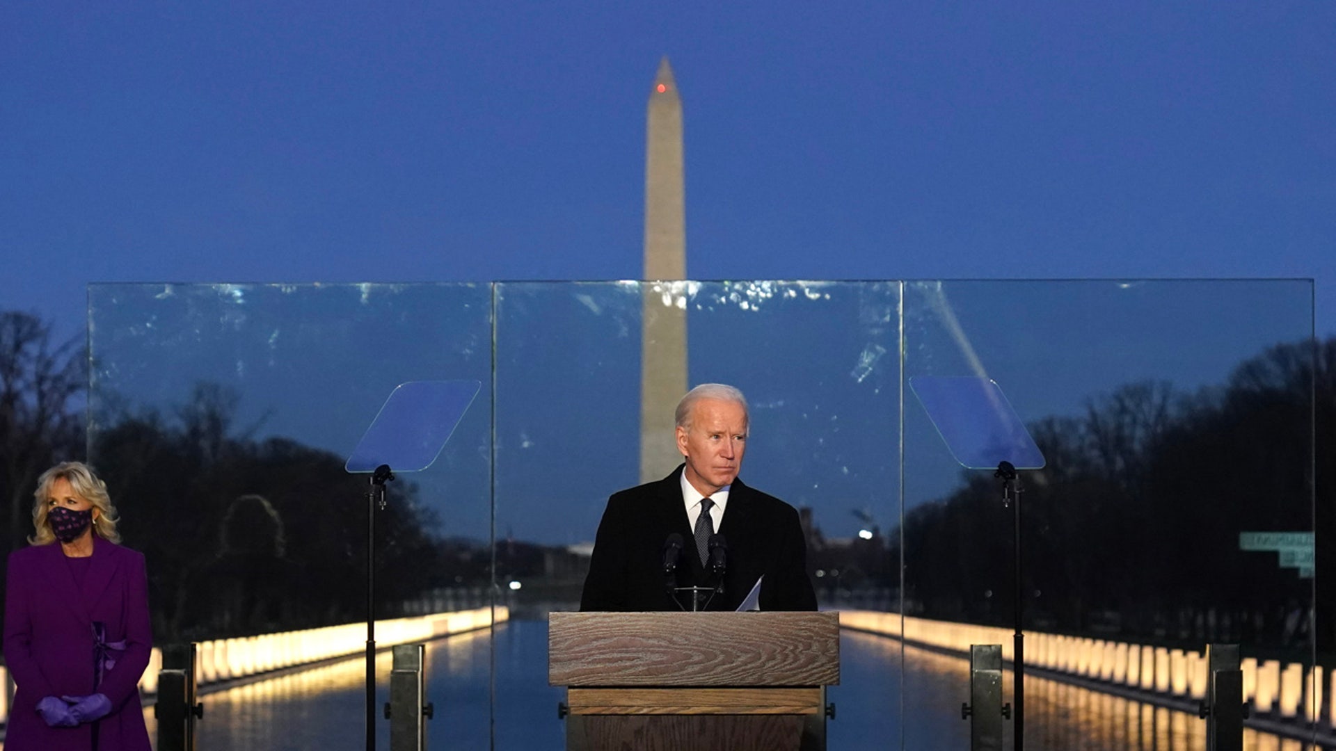 President-elect Joe Biden speaks during a COVID-19 memorial, with lights placed around the Lincoln Memorial Reflecting Pool, Tuesday, Jan. 19, 2021, in Washington.