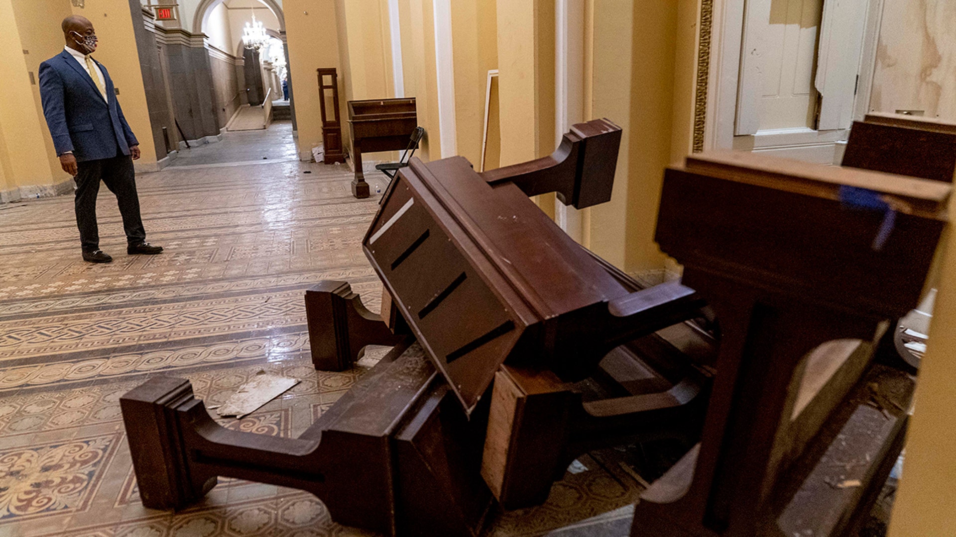 Sen. Tim Scott, R-S.C., stops to look at damage in the early morning hours of Thursday, Jan. 7, 2021, after protesters stormed the Capitol in Washington on Wednesday.