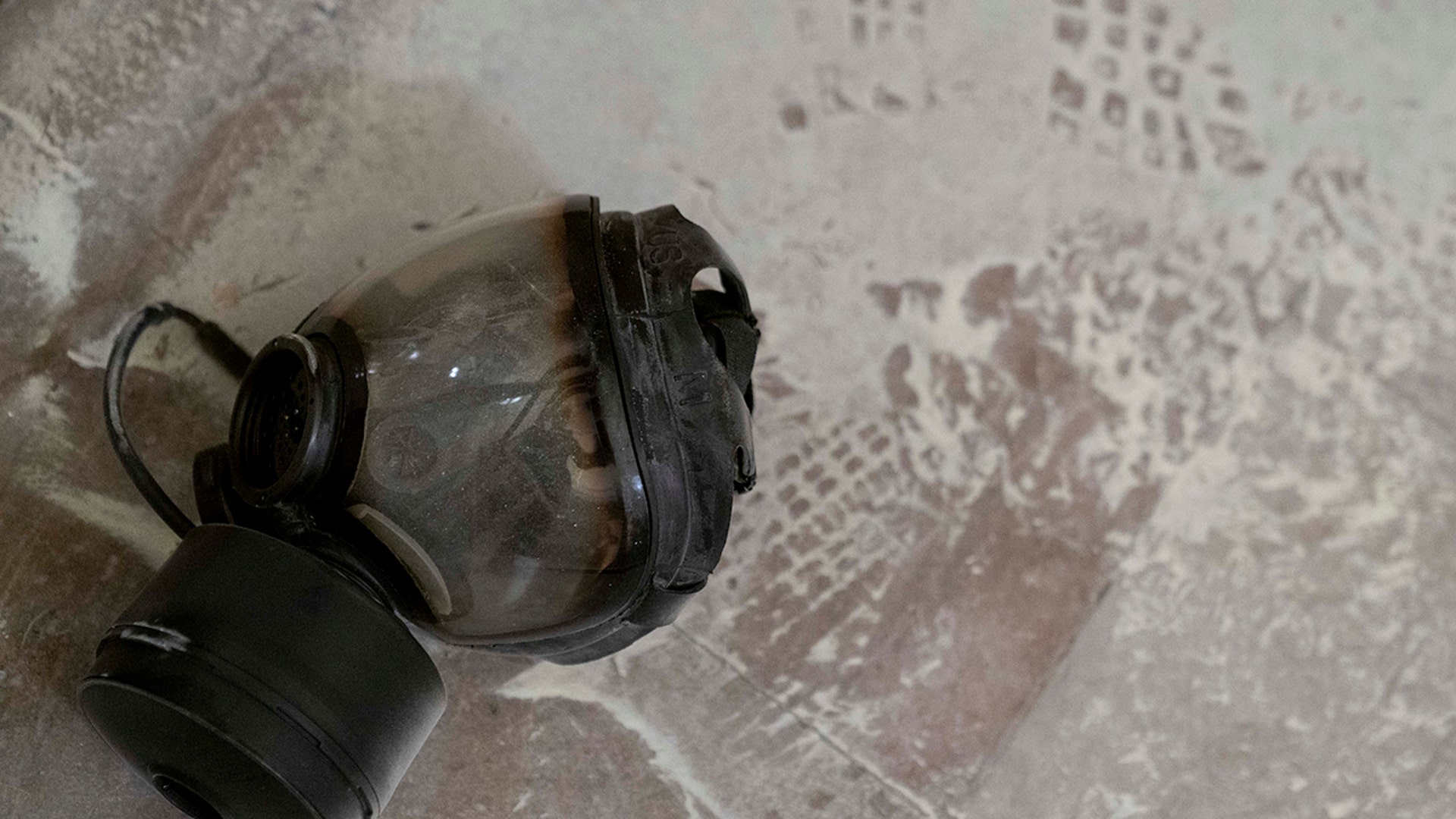 Dust and a gas mask are visible on the ground in the early morning hours of Thursday, Jan. 7, 2021, after protesters stormed the Capitol in Washington, on Wednesday.