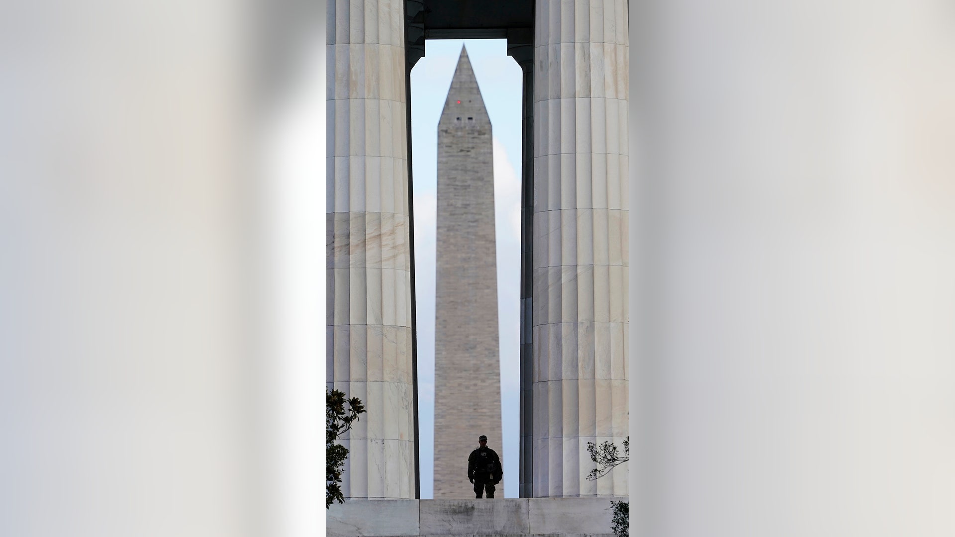 A National Guardsman stands at the Lincoln Memorial as the Washington Memorial looms in the background as security measures are heightened ahead of President-elect Joe Biden's inauguration ceremony, Monday, Jan. 18, 2021, in Washington.