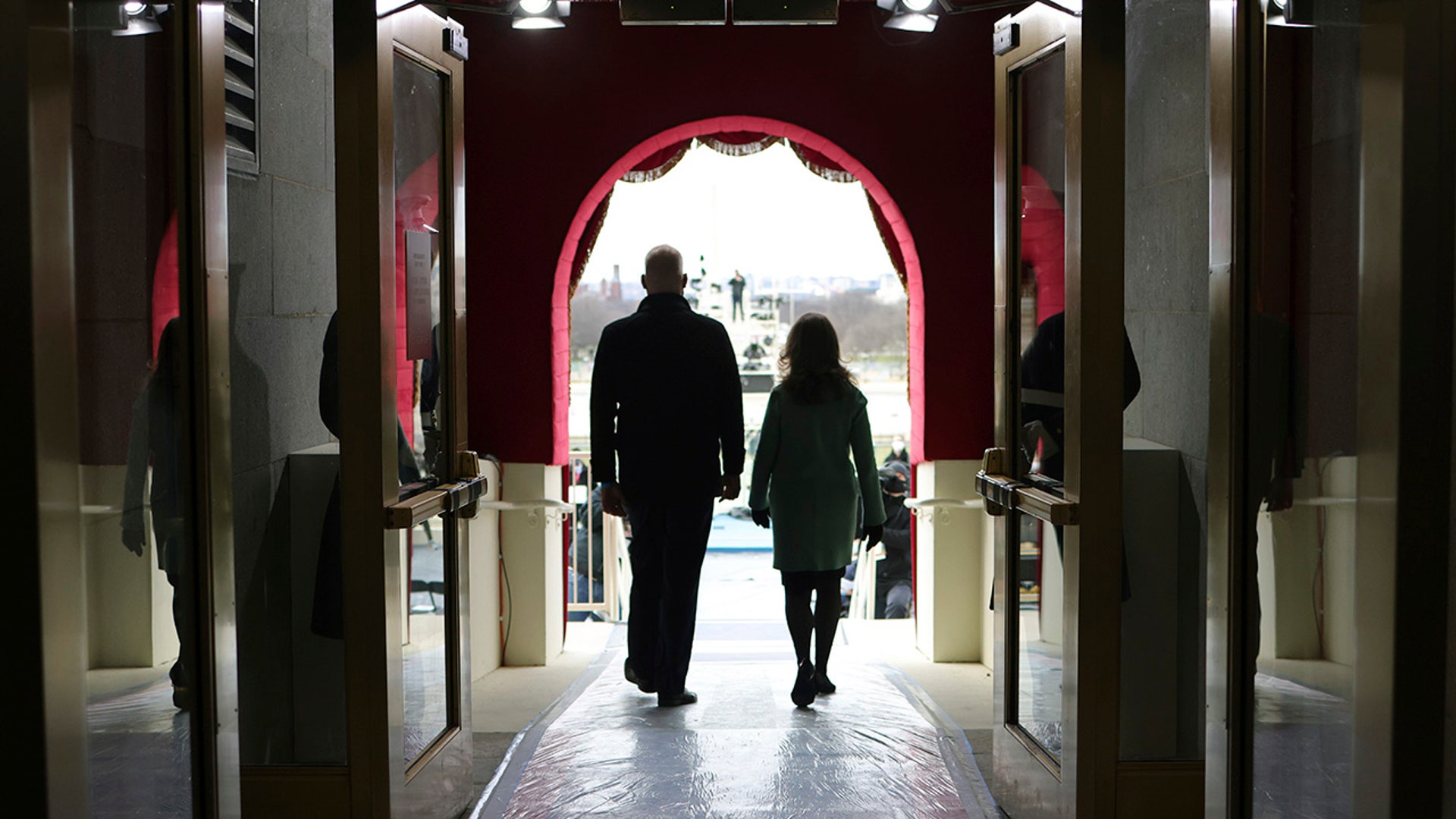 Stand-ins for President-elect Joe Biden and Jill Biden walk to the podium during a rehearsal for the 59th presidential inauguration at the U.S. Capitol in Washington, Monday, Jan. 18, 2021.