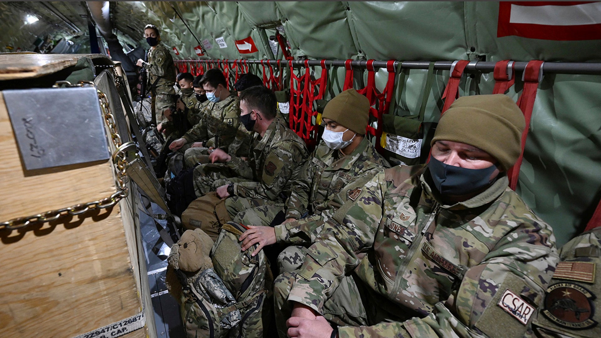 Guardsmen are seated on a KC-135 Stratotanker from the Alaska Air National Guard's 168th Wing as they prepare to depart from Joint Base Elmendorf-Richardson, Alaska, Sunday, Jan. 17, 2021, to assist with the Jan. 20 inauguration of President-elect Joe Biden in Washington.
