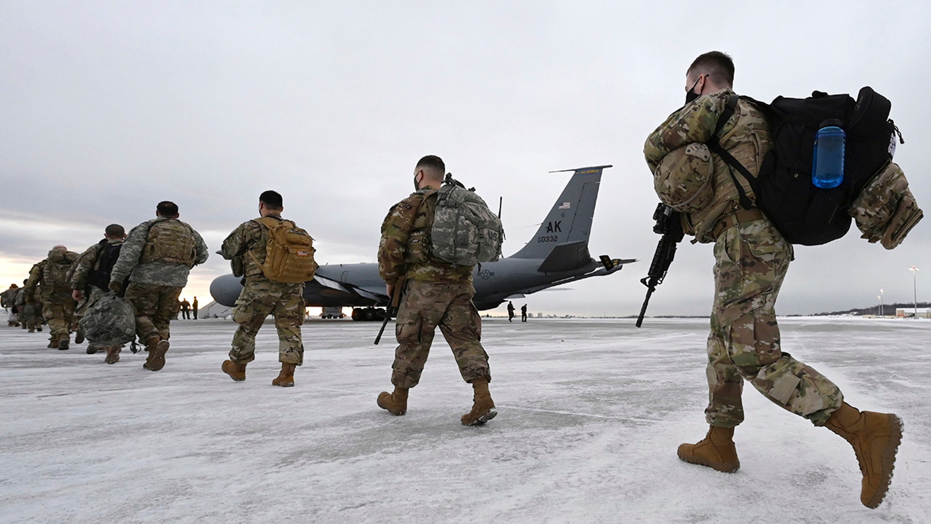 Airmen and soldiers from the Alaska National Guard prepare to depart from Joint Base Elmendorf-Richardson, Alaska, Sunday, Jan. 17, 2021, to assist with the Jan. 20 inauguration of President-elect Joe Biden in Washington. Approximately 80 Alaska Guardsmen volunteered and most of them will be transported by a KC-135 Stratotanker from the Alaska Air National Guard's 168th Wing at Eielson Air Force Base on a direct seven-hour flight to Joint Base Andrews in Maryland. (Bill Roth/Anchorage Daily News via AP)