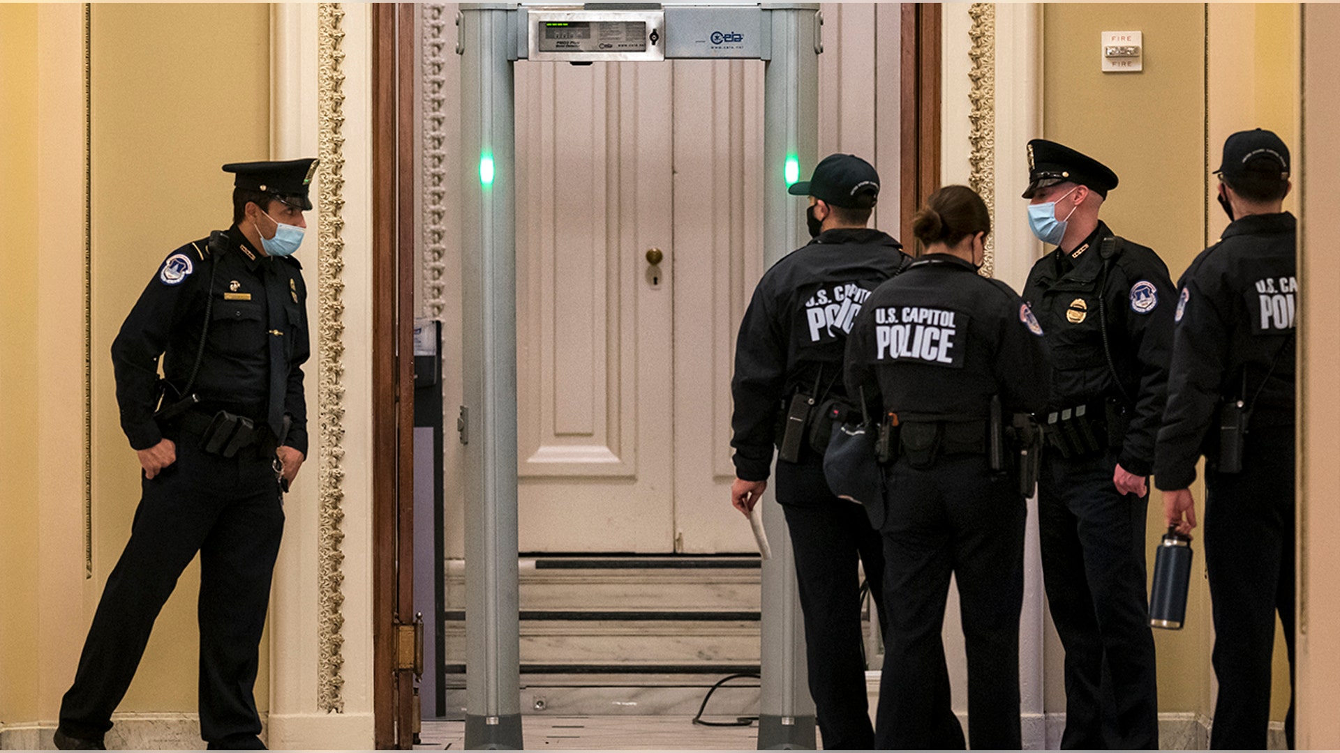 U.S. Capitol Police survey the corridor around the House of Representatives chamber after enhanced security protocols were enacted, including metal detectors for lawmakers, after a mob loyal to President Donald Trump stormed the Capitol, in Washington, Tuesday, Jan. 12, 2021.