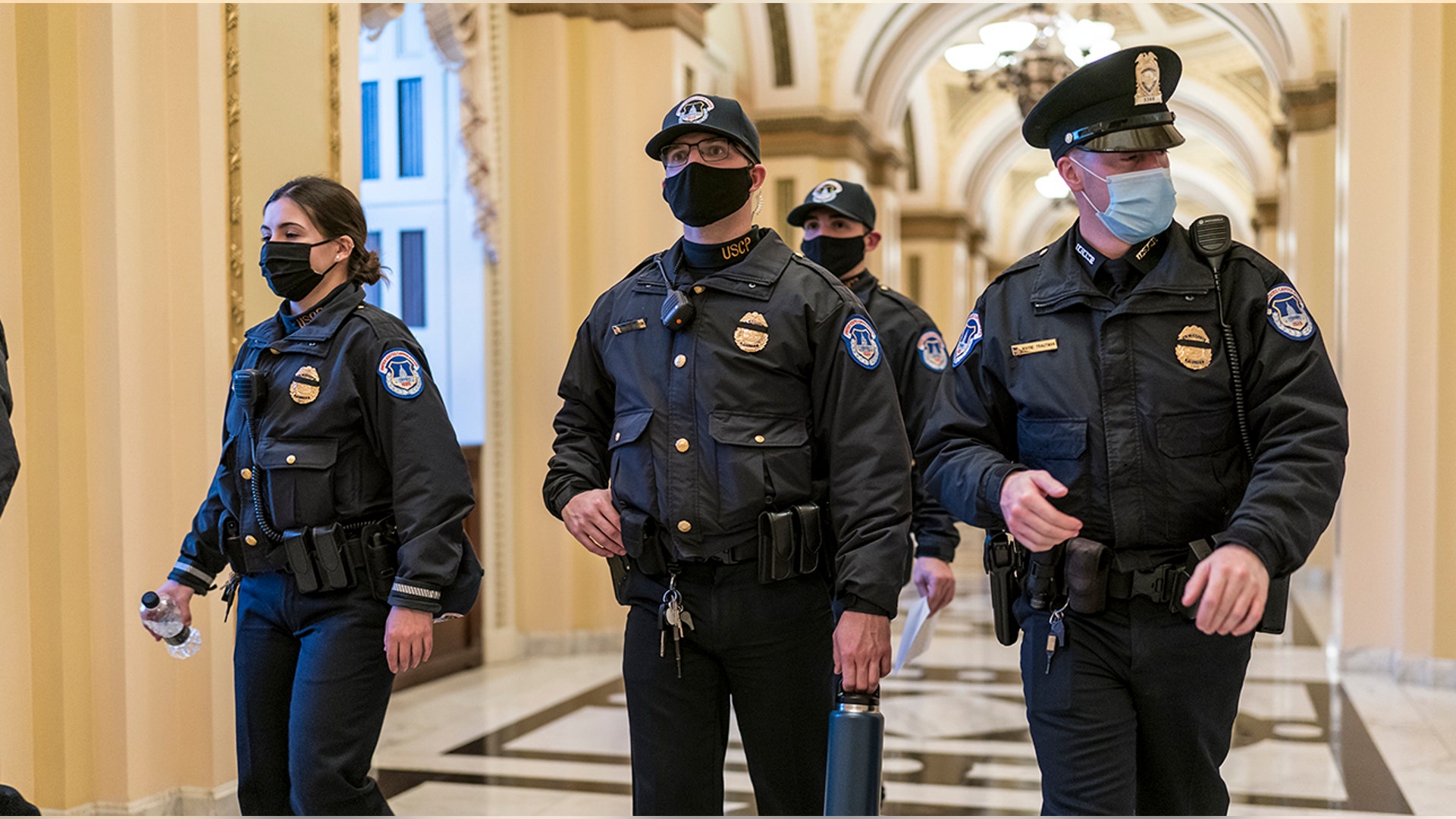U.S. Capitol Police survey the corridor around the House of Representatives chamber after enhanced security protocols were enacted, including metal detectors for lawmakers, after a mob loyal to President Donald Trump stormed the Capitol, in Washington, Tuesday, Jan. 12, 2021.