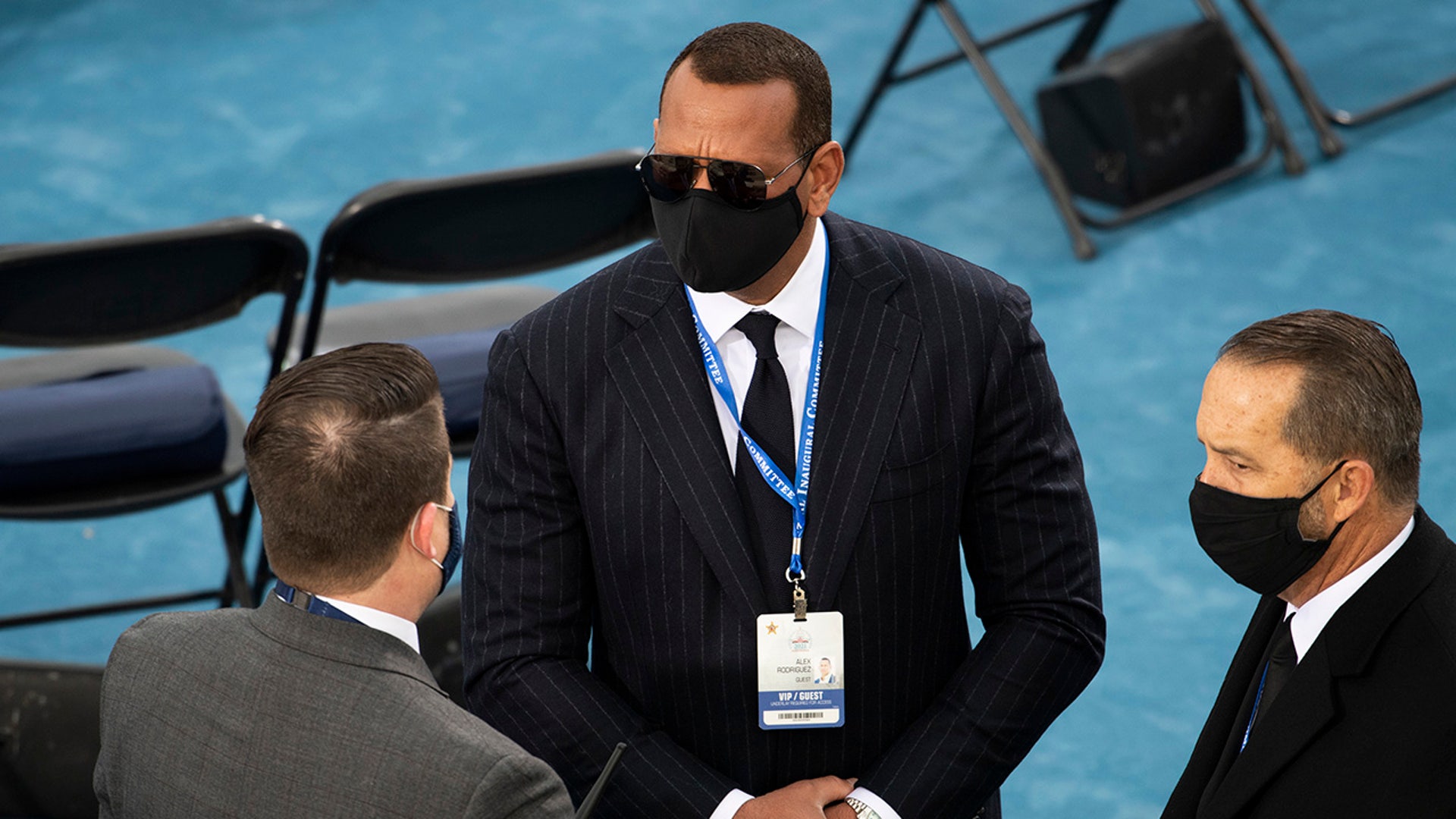 Former Major League Baseball player Alex Rodriguez, center, arrives to the West Front of the U.S. Capitol for the Inauguration of Joe Biden in Washington on Wednesday, Jan. 20, 2021. Rodriguez is engaged to Jennifer Lopez who is set to perform during the Inauguration ceremony.