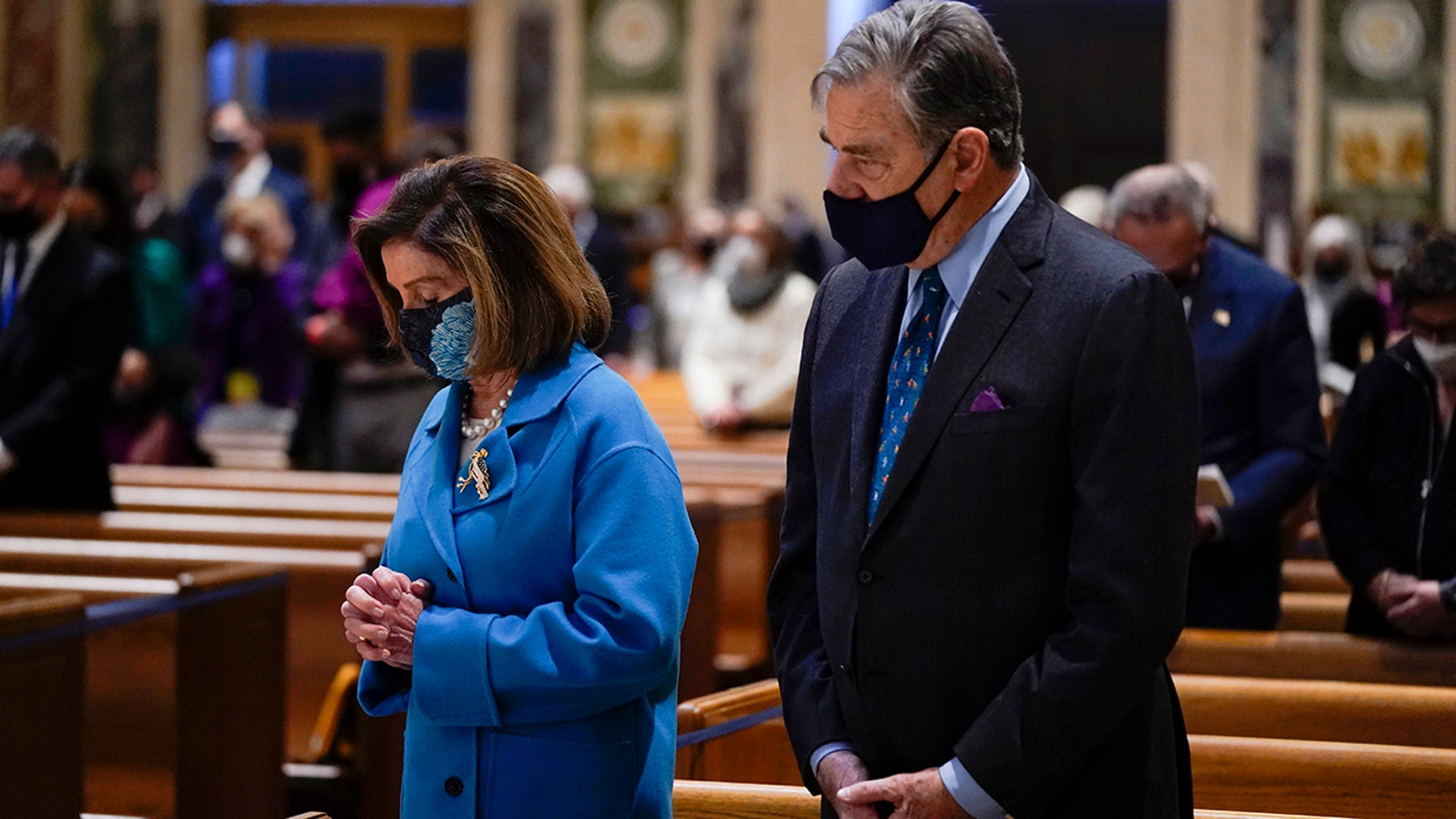 House Speaker Nancy Pelosi, left, and her husband Paul Pelosi attend Mass at the Cathedral of St. Matthew the Apostle during Inauguration Day ceremonies Wednesday, Jan. 20, 2021, in Washington. 
