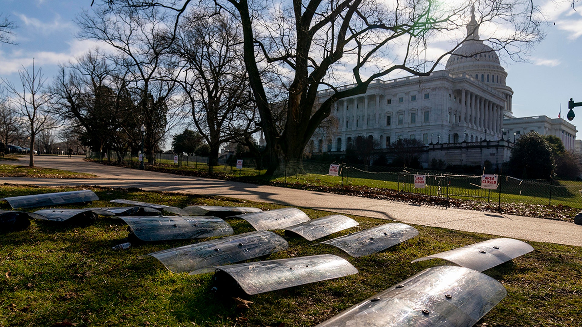 The Dome of the Capitol building is visible as riot gear is laid out on a field on Capitol Hill in Washington, Wednesday, Jan. 13, 2021. (AP Photo/Andrew Harnik)