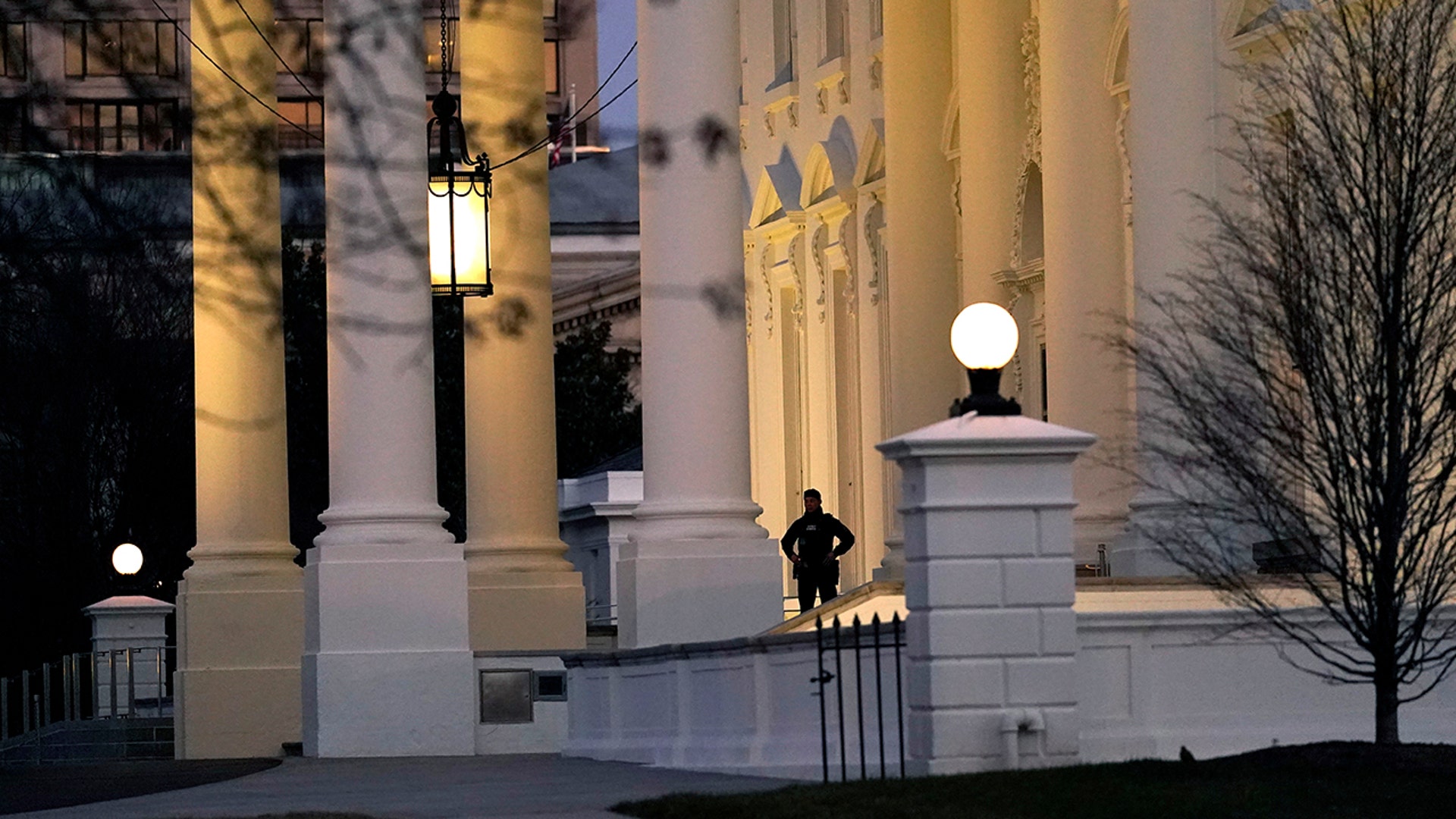 A U.S. Secret Service guard stands post at the North Portico of the White House, after the U.S. House impeached President Donald Trump in Washington, Wednesday, Jan. 13, 2021. (AP Photo/Gerald Herbert )