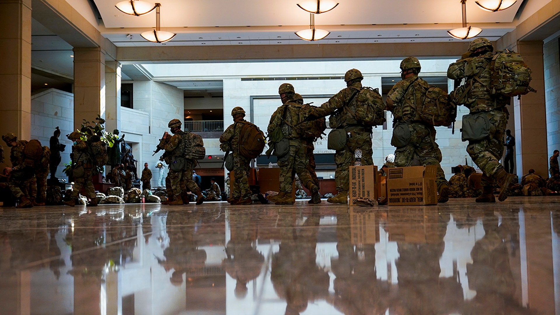 Troops move inside the Capitol Visitor's Center to reinforce security at the Capitol in Washington, Wednesday, Jan. 13, 2021. The House of Representatives is pursuing an article of impeachment against President Donald Trump for his role in inciting an angry mob to storm the Capitol last week. (AP Photo/Alex Brandon)