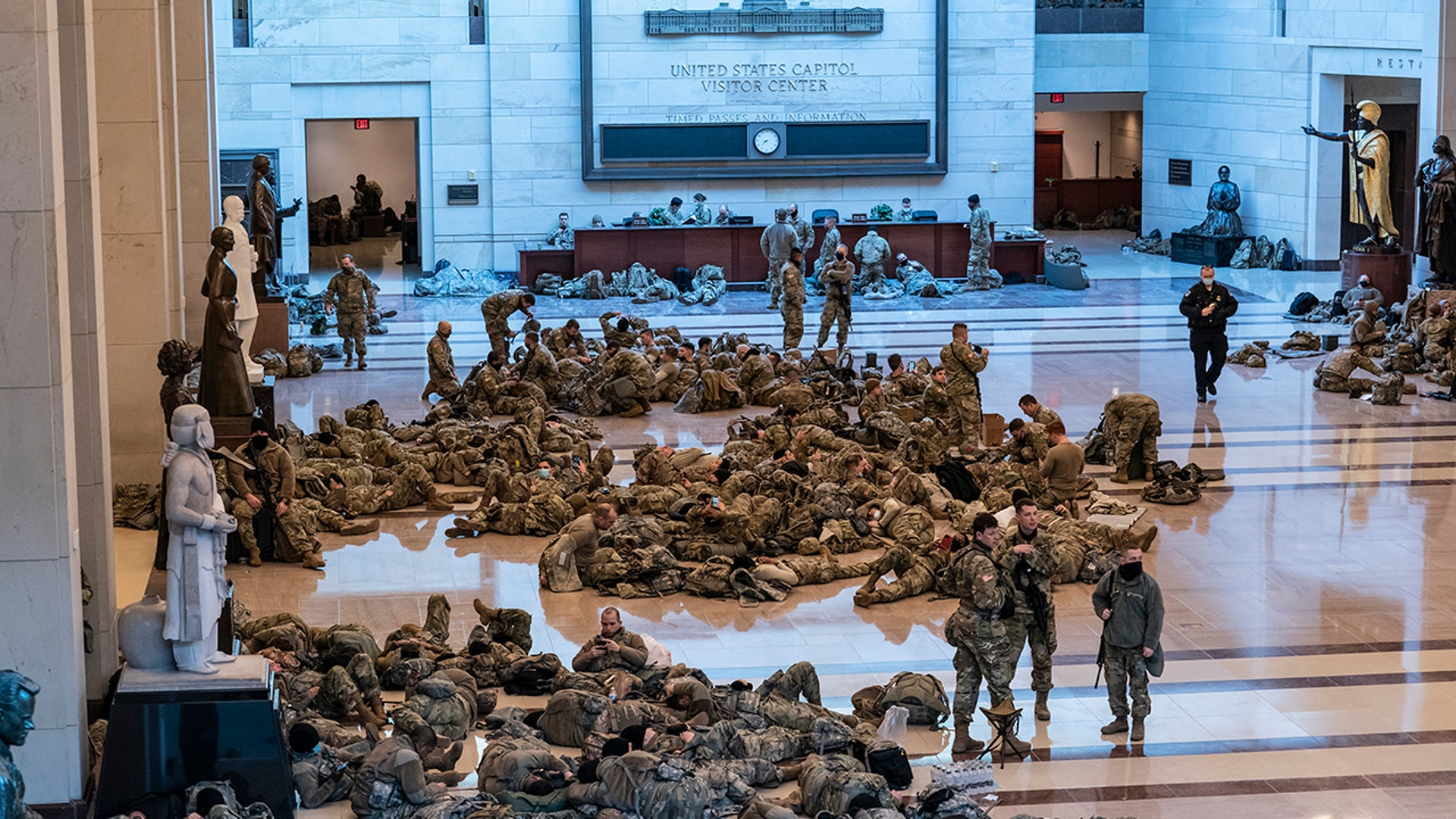 Hundreds of National Guard troops hold inside the Capitol Visitor's Center to reinforce security at the Capitol in Washington, Wednesday, Jan. 13, 2021. The House of Representatives is pursuing an article of impeachment against President Donald Trump for his role in inciting an angry mob to storm the Capitol last week. (AP Photo/J. Scott Applewhite