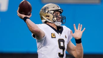 Saints' Drew Brees wearing custom cleats featuring MLB legends for playoff game vs. Bears