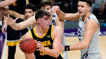 Garza scores 17, No. 5 Iowa routs Northwestern 96-73
