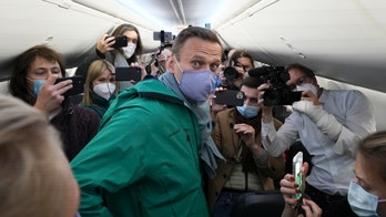 Supporters await Navalny’s return at Moscow airport, where he faces the threat of arrest