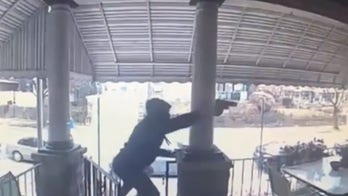 Philadelphia police searching for gunmen caught on video firing at least 20 shots at man on porch
