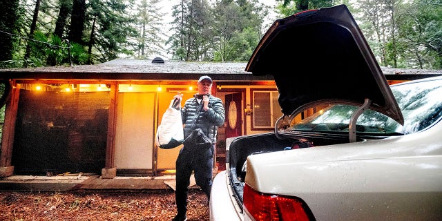 Charles Bogray evacuates from his Boulder Creek home near the CZU Lightning Complex Fire burn area in Santa Cruz County, Calif. On Tuesday, January 26, 2021 (AP Photo / Noah Berger)