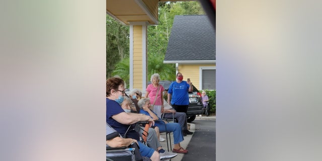 Photo of Rita Thomas (center) taken during her assisted living facility's drive-thru in August (Photo courtesy of the Thomas family).