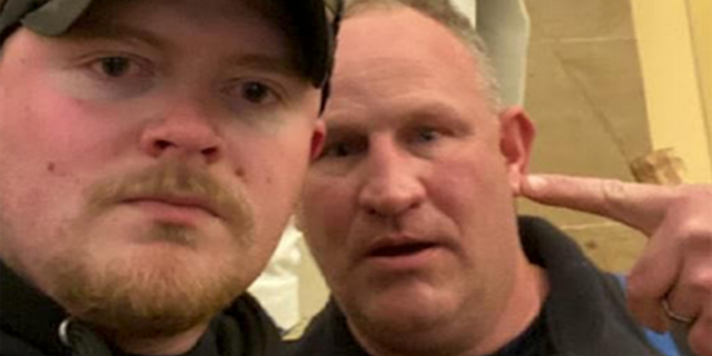 Police officers Jacob Fracker and Thomas Robertson took a selfie inside the U.S. Capitol during an insurrection. Fracker is a member of the National Guard, the Army said Friday.