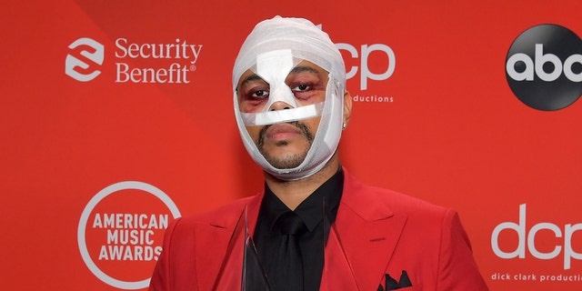 The Weeknd has appeared at a number of events wearing white bandages and artificial scars.  (Getty Images)