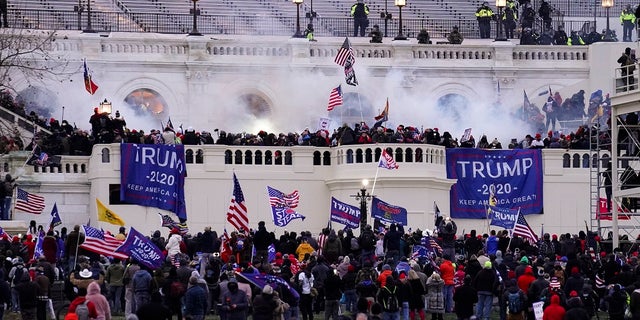 In this Wednesday, Jan. 6, 2021, file photo, violent protesters, loyal to President Donald Trump, storm the Capitol, in Washington. A Massachusetts teenager publicly called out her relatives after recognizing them as possible rioters during last week’s riot in Washington D.C.. (AP Photo/John Minchillo, File)