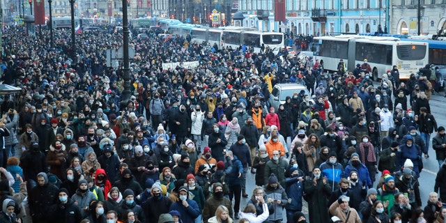 People march during a protest against the jailing of opposition leader Alexei Navalny in St.Petersburg, Russia, Saturday, Jan. 23, 2021. Russian police are arresting protesters demanding the release of top Russian opposition leader Alexei Navalny at demonstrations in the country's east and larger unsanctioned rallies are expected later Saturday in Moscow and other major cities. (AP Photo/Dmitri Lovetsky)