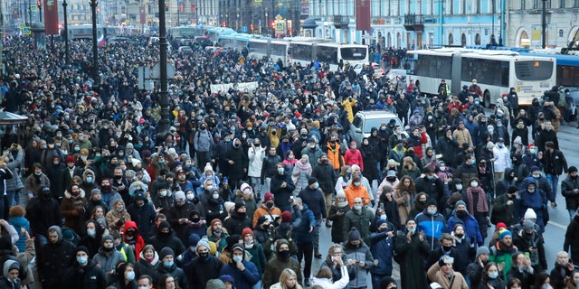 People march during a protest against the jailing of opposition leader Alexei Navalny in St.Petersburg, Russia, Saturday, Jan. 23, 2021. Russian police are arresting protesters demanding the release of top Russian opposition leader Alexei Navalny at demonstrations in the country's east and larger unsanctioned rallies are expected later Saturday in Moscow and other major cities. (AP Photo/Dmitri Lovetsky)