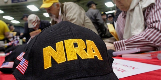 Illinois gun owners and supporters file NRA applications during an Illinois Gun Owners Lobby Day convention(AP Photo/Seth Perlman, File)