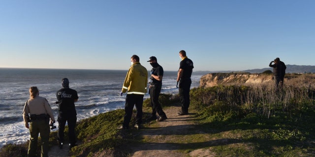Authorities look into the Pacific Ocean during a search for a California boy, 2, who was pulled under about 100 offshore.