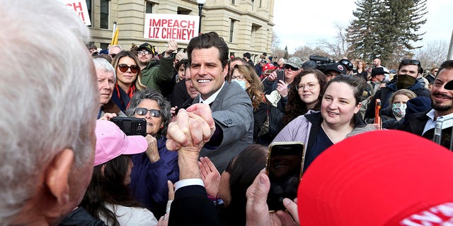 U.S. Rep. Matt Gaetz, R-Fla., grabs the hand of a supporter following a rally against U.S. Rep. Liz Cheney, R-Wyo., Thursday, Jan. 28, 2021, outside the Wyoming State Capitol in Cheyenne. Gaetz spoke to hundreds, bashing Cheney after she voted to impeach former President Donald Trump for his role in the Jan. 6 insurrection at the U.S. Capitol, and he called for a group effort in finding the right nominee to replace her when she is up for reelection in 2022. (Michael Cummo/The Wyoming Tribune Eagle via AP)