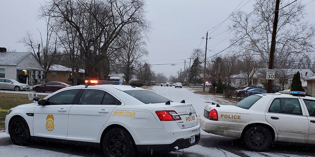 Indianapolis Metropolitan Police Department work the scene Sunday, Jan. 24, 2021, in Indianapolis where five people, including a pregnant woman, were shot to death early Sunday inside an Indianapolis home. (Justin L. Mack/The Indianapolis Star via AP)