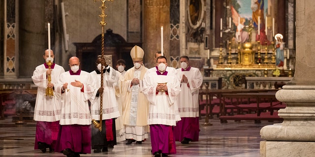 Cardinal Pietro Parolin, center, arrives in procession to celebrate a new year Mass in St. Peter's Basilica at the Vatican, Friday, Jan. 1, 2021. (AP Photo/Alessandra Tarantino, pool)