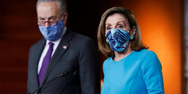FILE - In this Thursday, Nov. 12, 2020 file photo, Speaker of the House Nancy Pelosi, D-Calif., and Senate Minority Leader Chuck Schumer, D-N.Y., meet with reporters on Capitol Hill in Washington. (AP Photo/J. Scott Applewhite, File)