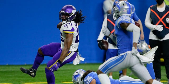 Minnesota Vikings running back Alexander Mattison (25) breaks away from Detroit Lions outside linebacker Jahlani Tavai for a touchdown during the first half of an NFL football game, Sunday, Jan. 3, 2021, in Detroit. (AP Photo/Duane Burleson)