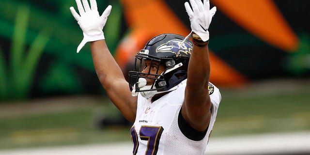 Baltimore Ravens running back J.K. Dobbins (27) celebrates after scoring a touchdown against the Cincinnati Bengals during the second half of an NFL football game, Sunday, Jan. 3, 2021, in Cincinnati. (AP Photo/Aaron Doster)
