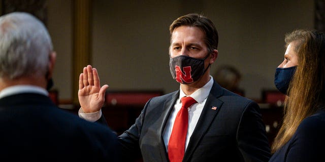 Sen. Ben Sasse, R-Neb., is joined by his wife Melissa Sasse, as he take the oath of office from Vice President Mike Pence during a reenactment ceremony in the Old Senate Chamber at the Capitol in Washington, Sunday, Jan. 3, 2021. (Pete Marovich/The New York Times via AP, Pool)