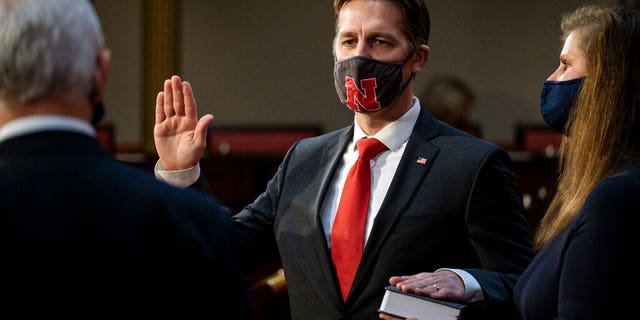 Sen. Ben Sasse, R-Neb., is joined by his wife Melissa Sasse, as he take the oath of office from Vice President Mike Pence during a reenactment ceremony in the Old Senate Chamber at the Capitol in Washington, Sunday, Jan. 3, 2021. (Pete Marovich/The New York Times via AP, Pool)